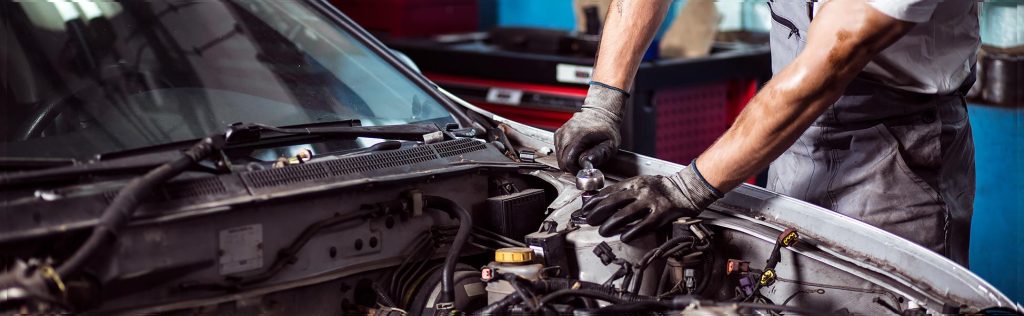 A Certified Mechanic works on a GMC vehicle engine