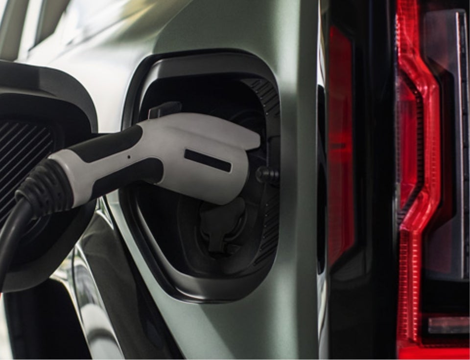 Close up of charging port with charger plugged in on a GMC Hummer EV SUV - Rodenroth Motors GMC in Sault Ste Marie MI