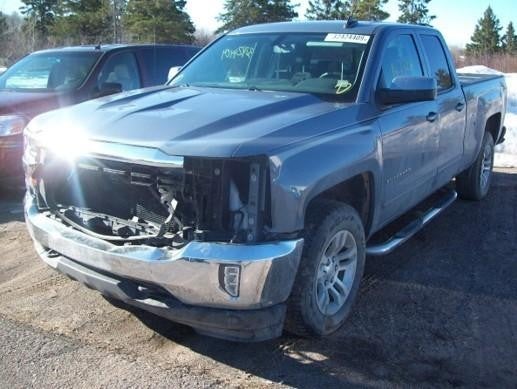 Damaged GMC Sierra 1500 with missing front grille and headlights
